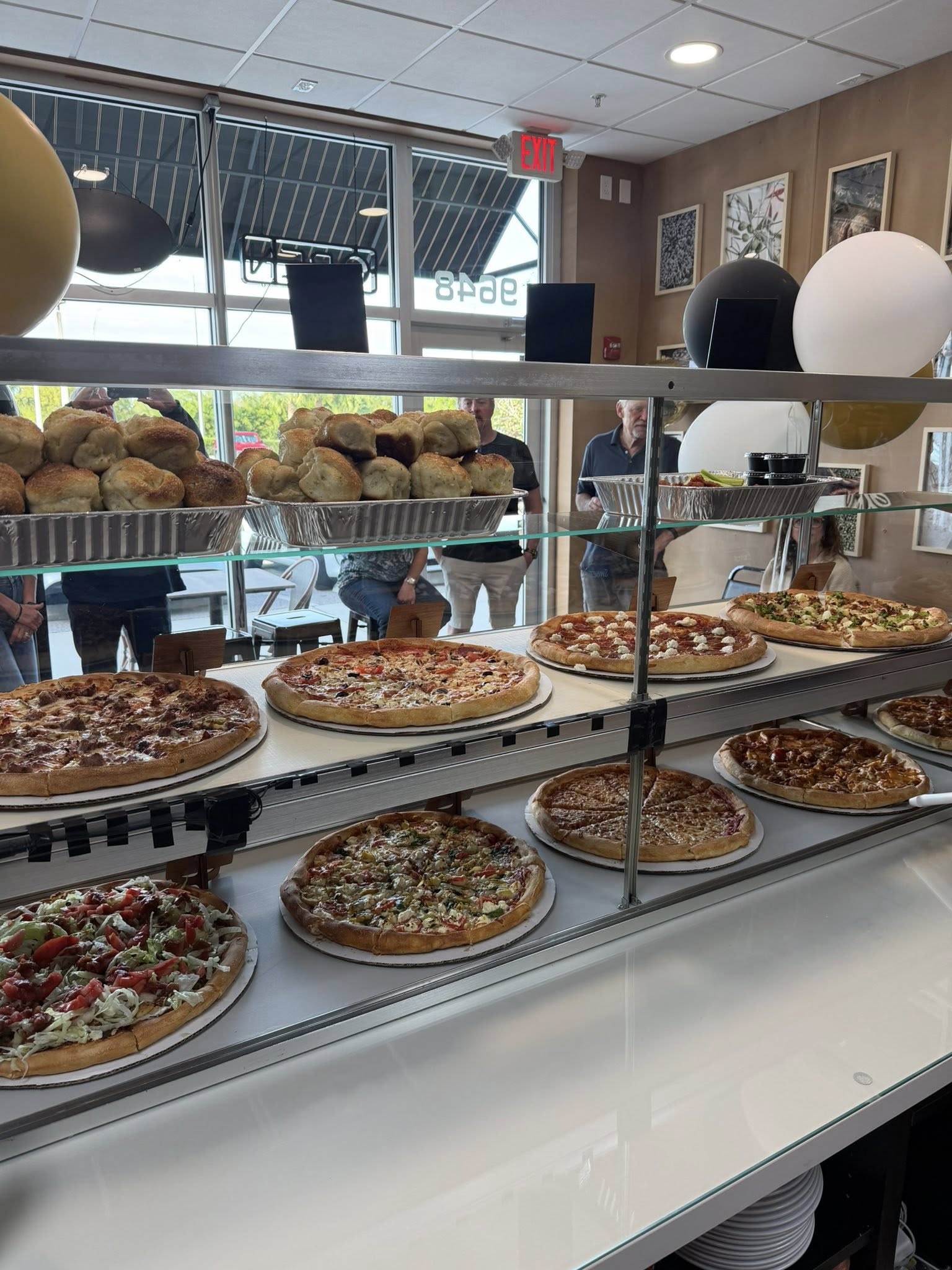 Our pizza display case — fresh made daily